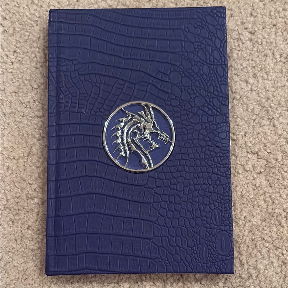 Unused Blue leather Notebook with silver dragon emblem.